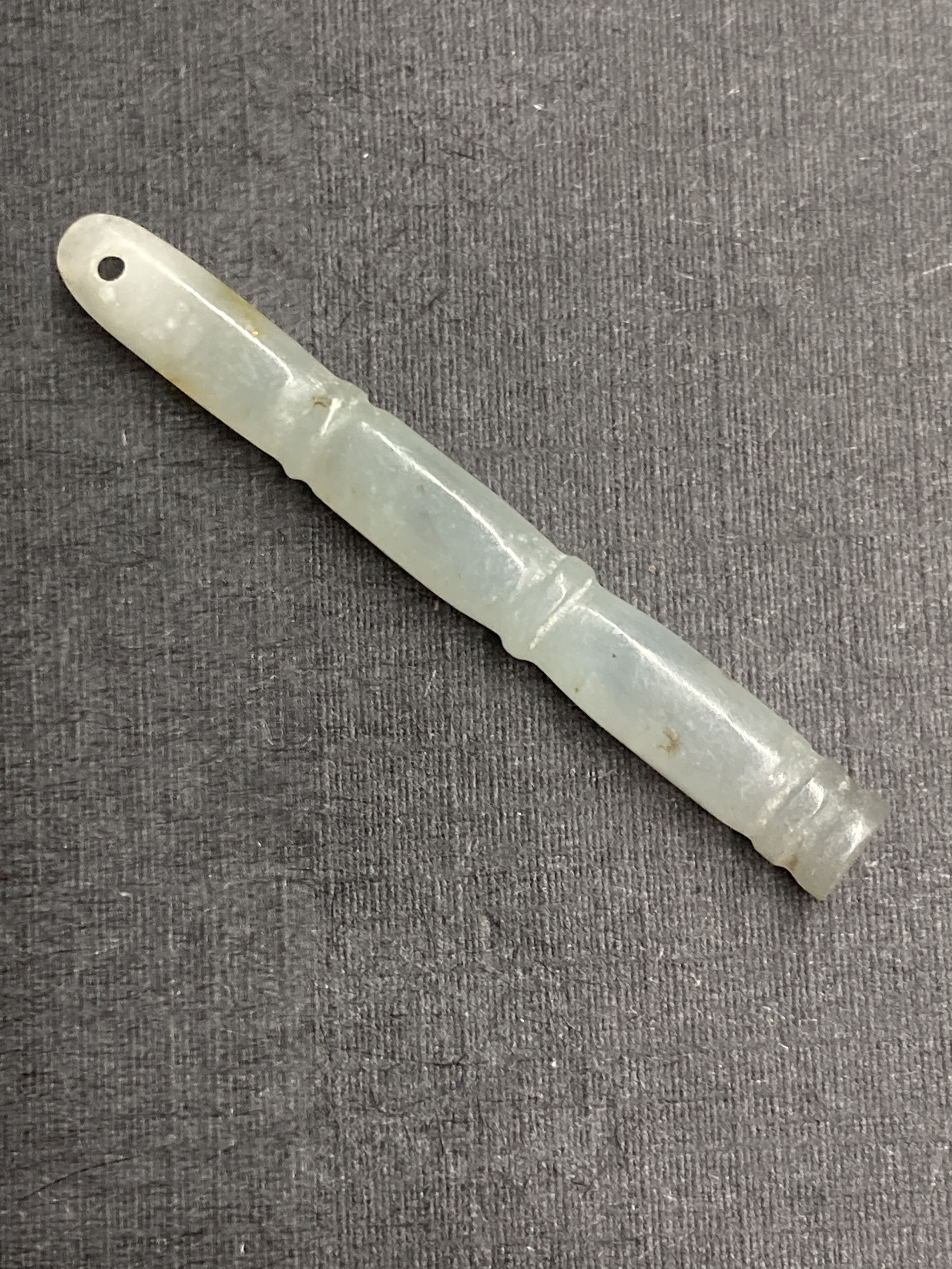 A Chinese jadeite gourd pendant, largest 43mm and two hardstone faux bamboo pendants.